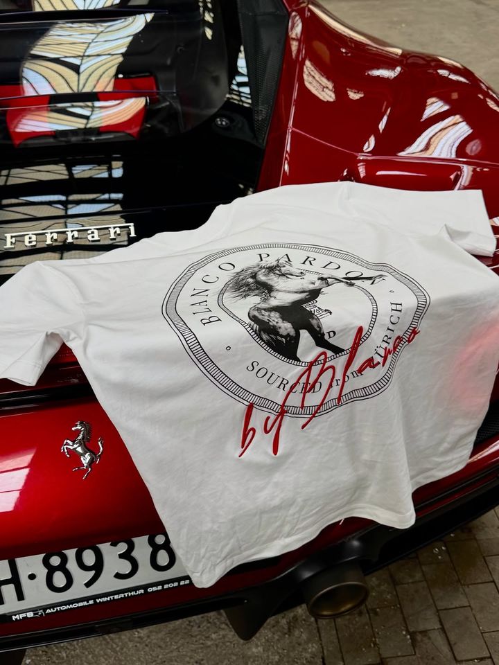 White Mustang T-shirt by BLANCO PARDON lying on a red Ferrari