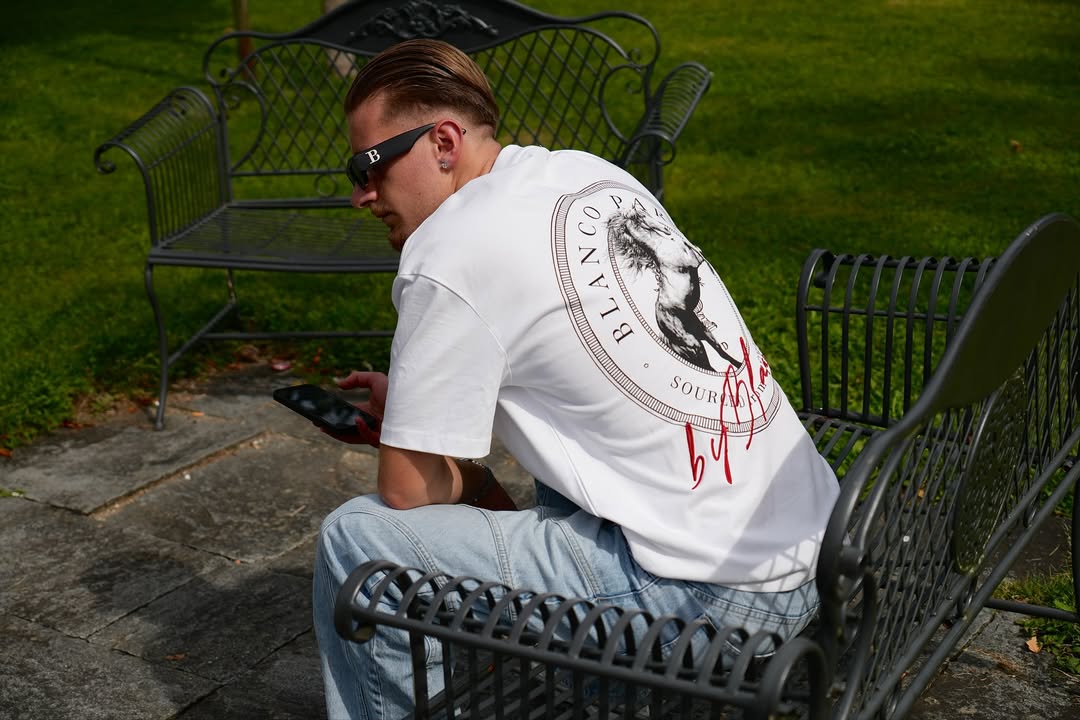 Man in the White Mustang T-shirt sitting on a park bench